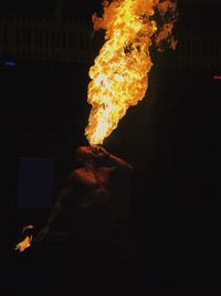 Fire-eater performing during night