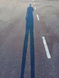 Shadow of man on road