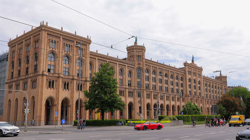 Cars on street against sky