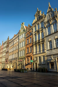 Low angle view of buildings against blue sky