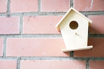 Close-up of birdhouse on wall