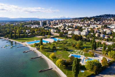 High angle view of buildings and trees against sky