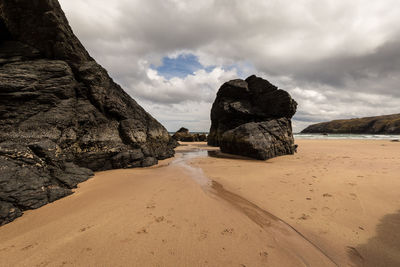 Rocks on beach against sky