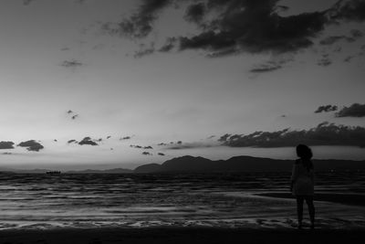 Rear view of woman standing on beach