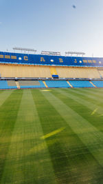 Low angle view of soccer field against clear sky