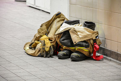 Fireman trousers and boots on sidewalk in city