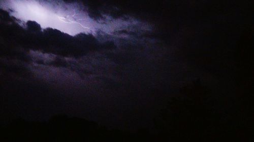 Low angle view of dramatic sky at night