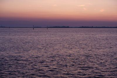 Scenic view of sea against romantic sky at sunset