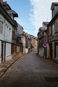 Empty alley amidst houses in town