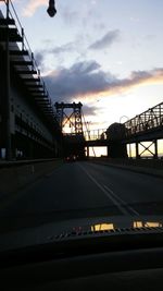 Railroad track against sky at sunset