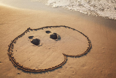 Heart shape on shore at sandy beach