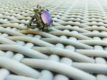 Close-up of ring on wicker table