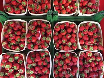 Full frame shot of strawberries in crates at market