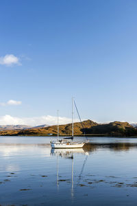 Sailboat on sea against sky