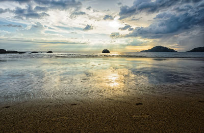 Scenic view of beach against sky during sunset
