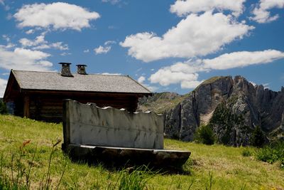 Built structure on field against sky