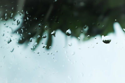 Full frame shot of wet glass window in rainy season