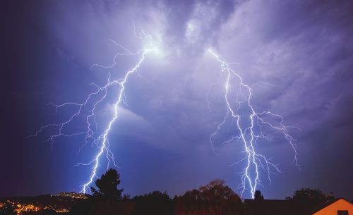 Low angle view of lightning in sky at night