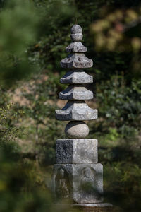Close-up full frame of a memorial column of stone like a pagoda