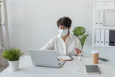 Young woman using laptop at home