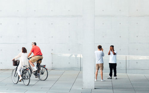 Full length of man and woman standing on wall