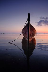 Reflection of clouds in sea at sunset