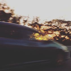 Close-up of car on road against sky