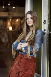 Portrait of beautiful young woman standing at home