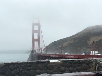 Golden gate bridge over river against sky