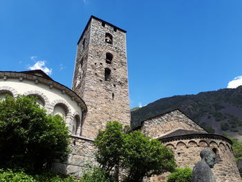 Low angle view of old building against clear blue sky