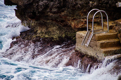 Water flowing through rocks in sea