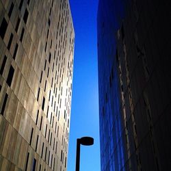 Low angle view of modern building against blue sky