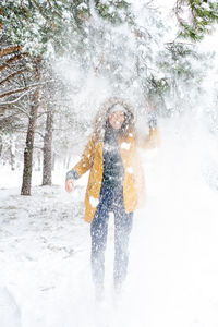 Full length of woman standing on snow covered land