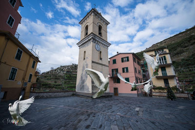 Low angle view of buildings in city against sky