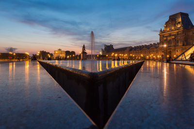 Musee du louvre against sky at dusk