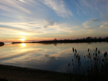 Scenic view of lake at sunset