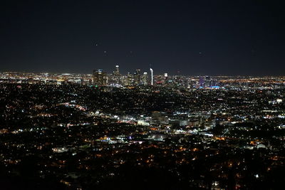 High angle view of city lit up at night