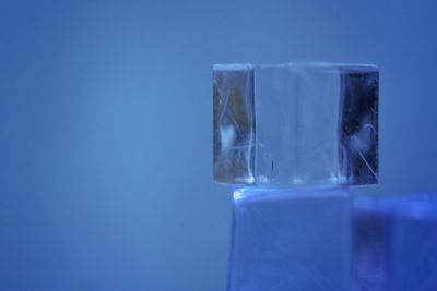 Close-up of ice cubes against blue background
