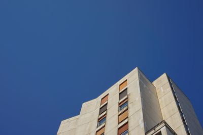 Low angle view of building against clear blue sky