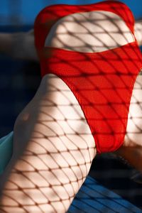 Midsection of woman standing on couch