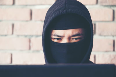Close-up of hacker wearing mask