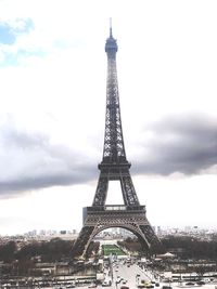 Communications tower against cloudy sky