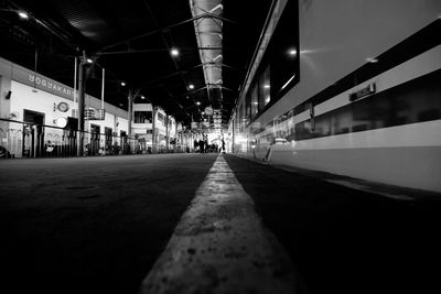 Close-up of illuminated railroad station against sky at night