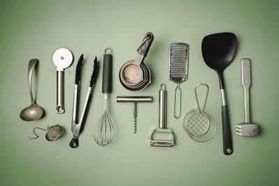 High angle view of kitchen utensils on yellow background