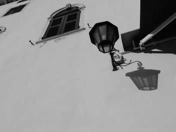 Low angle view of lighting equipment on wall