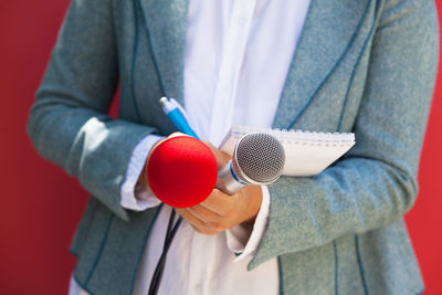 Midsection of man holding umbrella