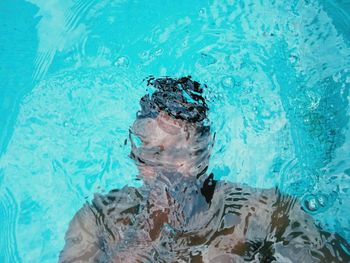 Portrait of a man swimming in pool