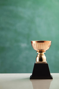 Trophy against blackboard on table