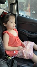 Midsection of woman sitting in car