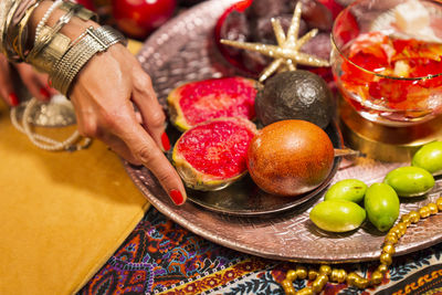 Midsection of woman holding fruits in plate